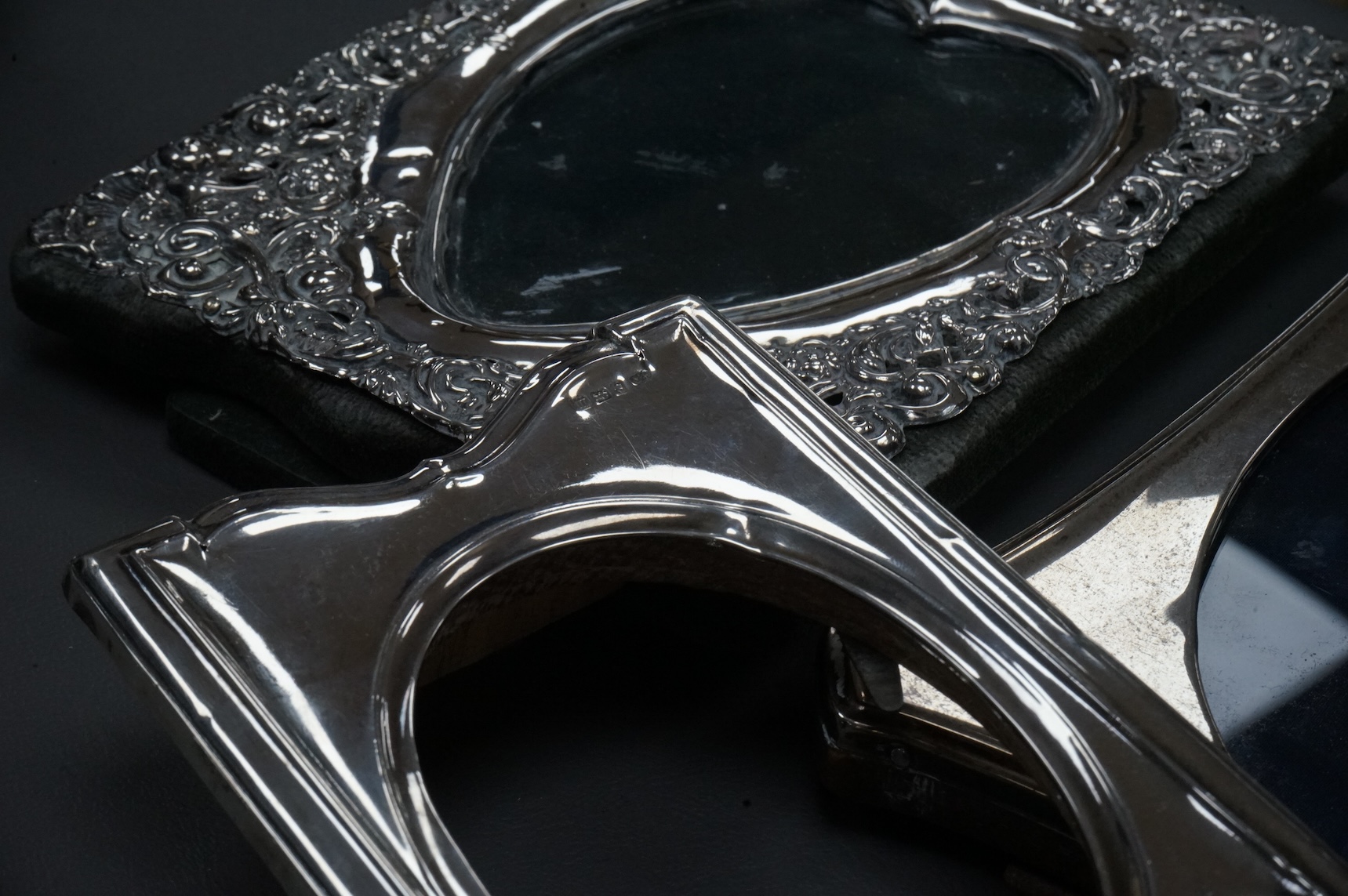 Four assorted early 20th century silver mounted photograph frames, the largest with pierced decoration, Chester, 1902, 19.5cm.
